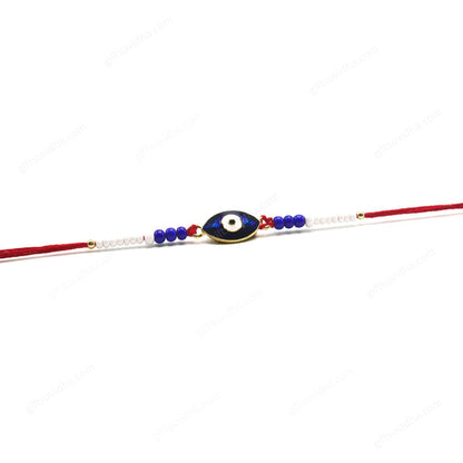 Close-up of the Oval Evil Eye Rakhi showcasing the glittery opal-like resin eye, reflective quality, and intricate beadwork