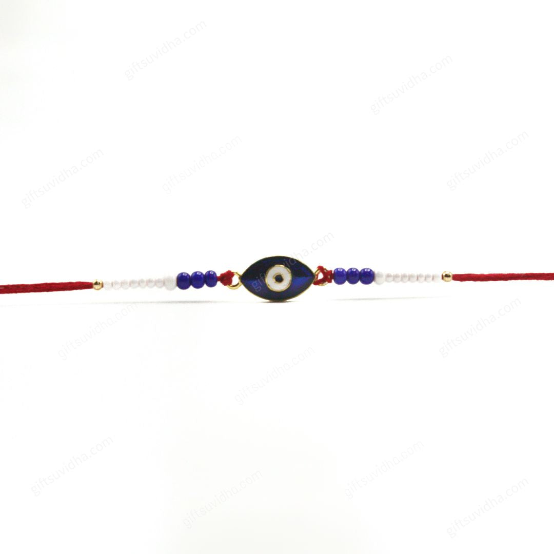 Oval Evil Eye Rakhi with a glossy blue resin eye, accented by red threads and blue and white beads for a striking, protective charm.