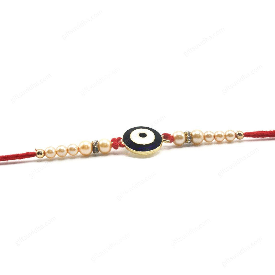 Round Evil Eye Rakhi with a glittery blue resin eye, reflective metallic base, and traditional red threads adorned with motis