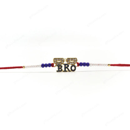 Cool Bro Rakhi with a trendy goggle design, vibrant 'Bro' lettering, and a rim adorned with sparkling diamonds, on red threads with blue and white beads.